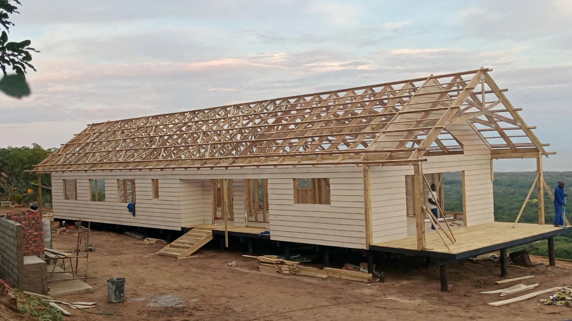Nutec home under construction with timber roof trusses on a timber deck